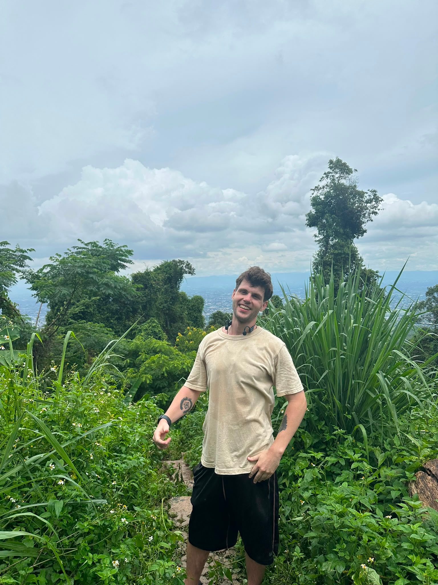 On a mountain trail above the city, jungle on both sides