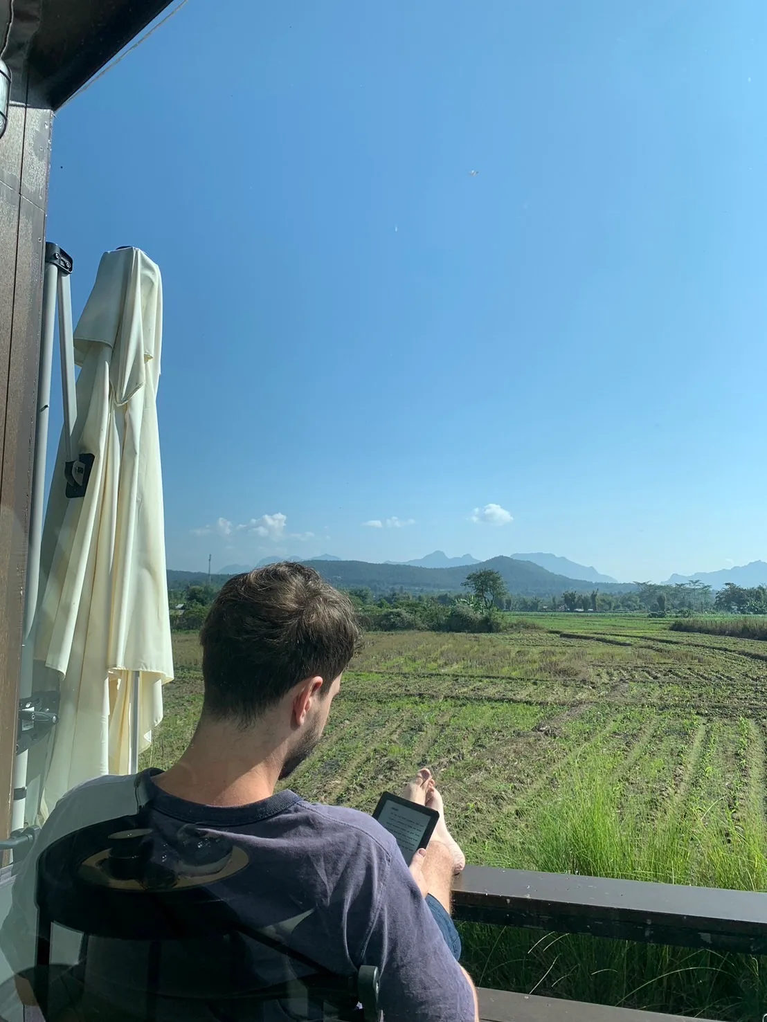 Reading outdoors looking out over rice fields